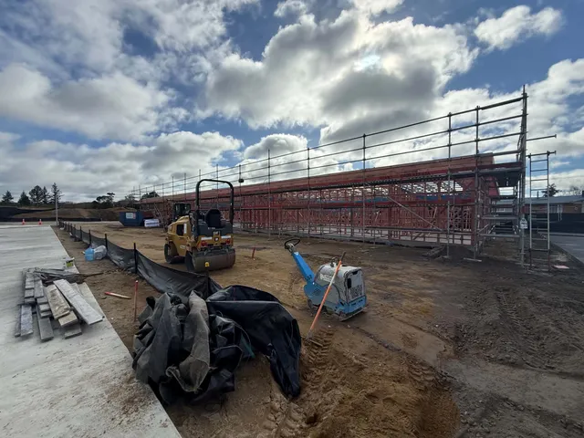 Wide view of the building frame from the concrete footpath