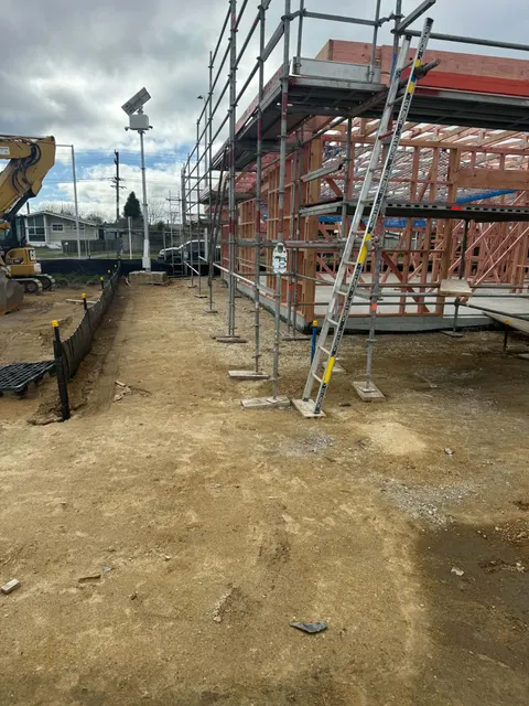 Close view of scaffolding and timber framing at the building corner